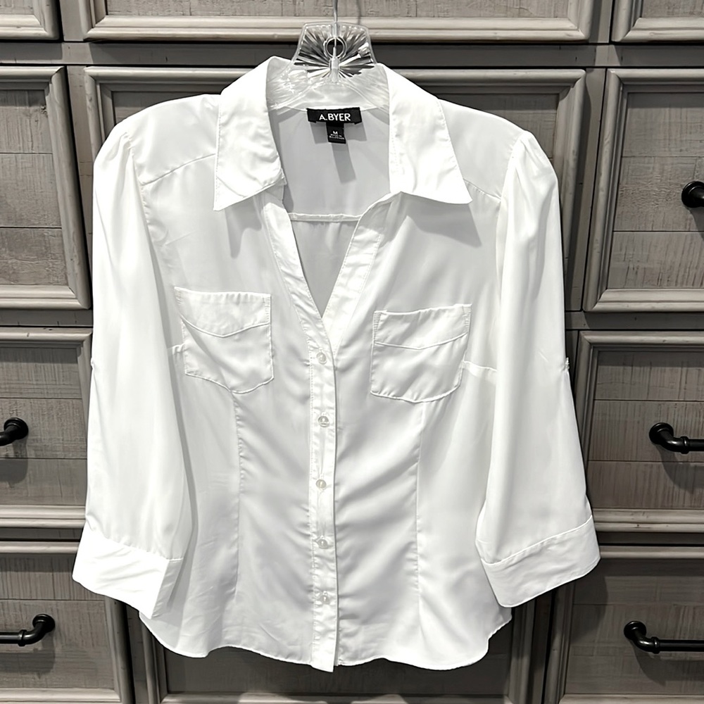 A. Byer cream colored 3/4 sleeve button up blouse.